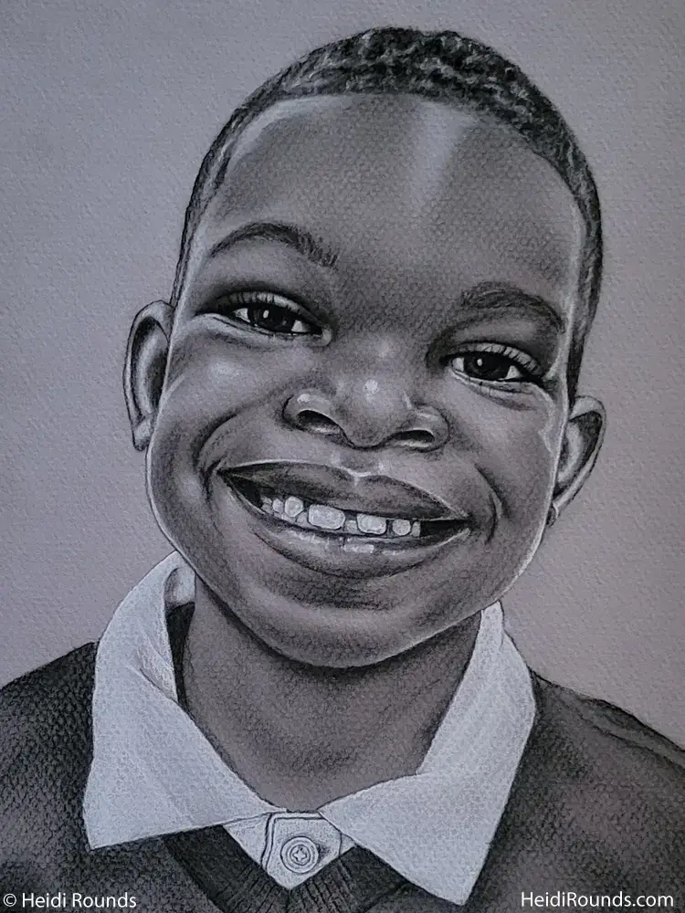 "Commissioned Portrait Drawing of a Little Boy" 8"x10" charcoal/pastel portrait drawing on toned paper by Heidi Rounds. A little boy in a collard shirt smiling.